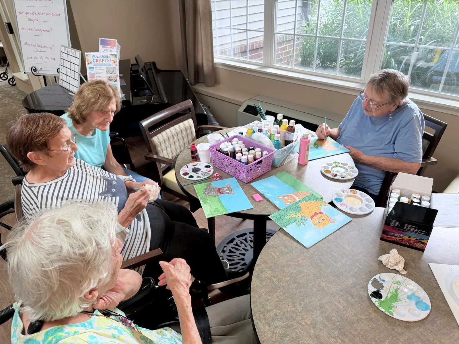 Residents painting in the creative arts studio at Comfort Cove Senior Living in West Bloomfield, MI